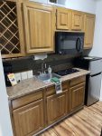 Kitchen equipped with mini fridge, two burner electric stove and microwave